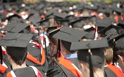 Large crowd of students in graduation garb