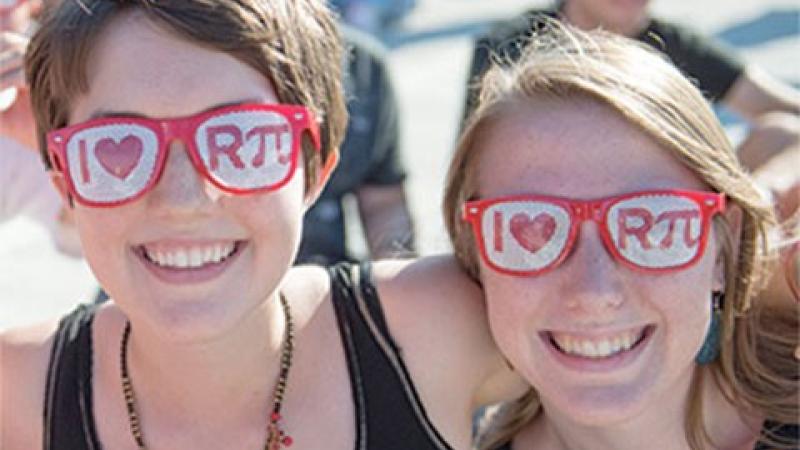 Two students wearing "I heart R(pi)" glasses